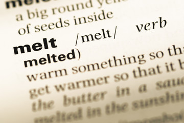 Fototapeta premium Close up of old English dictionary page with word melt