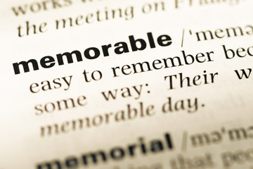 Obraz premium Close up of old English dictionary page with word memorable