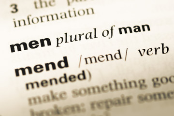 Close up of old English dictionary page with word men