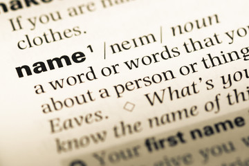 Close up of old English dictionary page with word name