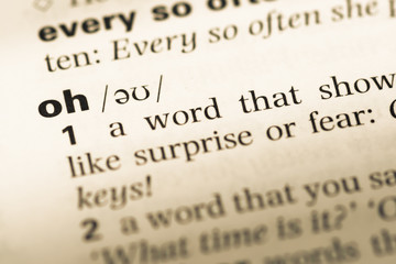 Close up of old English dictionary page with word oh