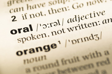 Fototapeta premium Close up of old English dictionary page with word oral
