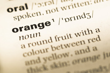 Close up of old English dictionary page with word orange