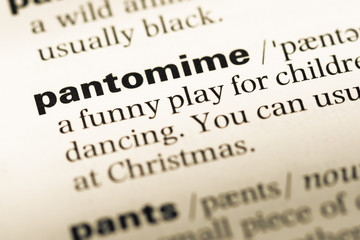 Close up of old English dictionary page with word pantomime