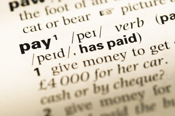 Fototapeta premium Close up of old English dictionary page with word pay