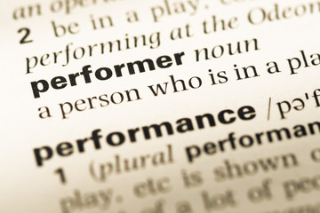 Fototapeta premium Close up of old English dictionary page with word performer
