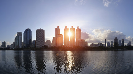 Building on the early morning light of Benjakiti Park in Bangkok