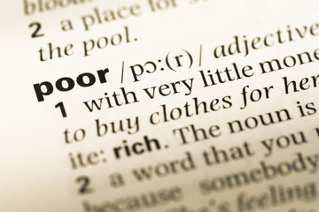 Fototapeta premium Close up of old English dictionary page with word poor