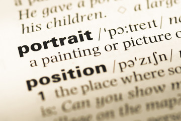 Fototapeta premium Close up of old English dictionary page with word portrait