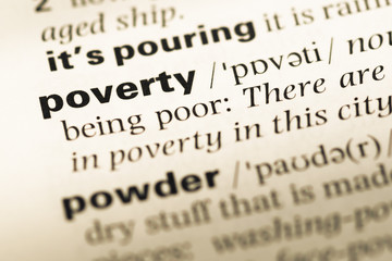 Fototapeta premium Close up of old English dictionary page with word poverty