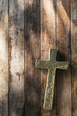 gold cross on wooden background