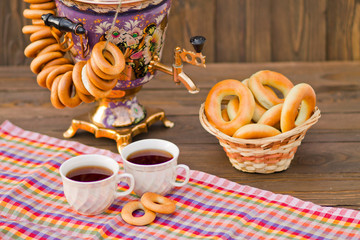 Samovar Tea cup and donut on a napkin in a cage