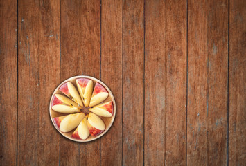 Top view of sliced apple on wooden background