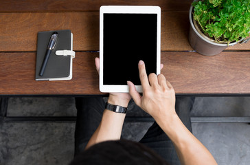 Close up of mans hands using tablet on counter, Image taken from