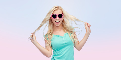 happy young blonde woman or teenager in sunglasses