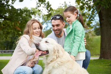 happy family with labrador retriever dog in park