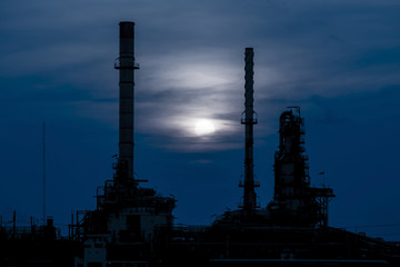 Silhouette of oil refinery factory in night