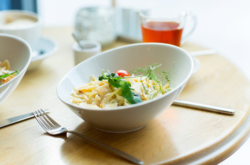 close up of pasta in bowl on table at restaurant