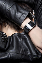 Black smart watch on a female model wearing stylish punk style leather