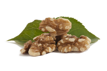 peeled walnuts with green leaves