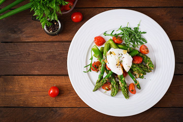 Salad of asparagus, tomatoes and poached egg. Top view