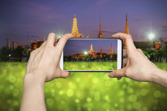 Taking pictures on mobile smart phone in Wat Phra Kaew (The Emer