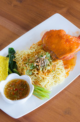 Chicken noodle In white plate on the table