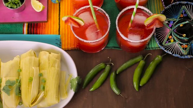 Party table with tamales, strawberry margaritas and pan dulche bread