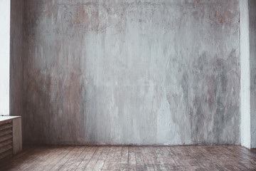 Room interior. Cement wall and wooden floor.