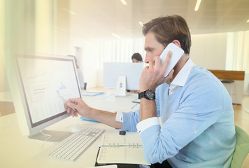 Bank trader negotiating on the phone from office