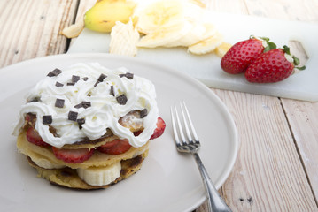 pancakes with strawberries, banana, blueberries and chocolate...
