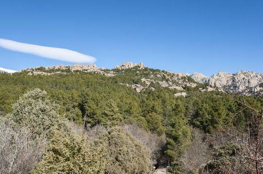 Views of La Pedriza from Canto Cochino, in Guadarrama Mountains National Park, Madrid, Spain. In the background can be seen The Cancho de los Muertos Peak, El Pajaro  Peak and Las Buitreras Peak