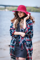 beautiful young brown-haired woman with long hair walking near the river