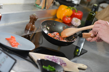 Chef in restaurant kitchen at stove