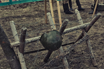 Reconstruction of life and subjects of second world war, anti-tank barrier and helmet