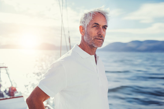 Portrait of mature man standing on boat