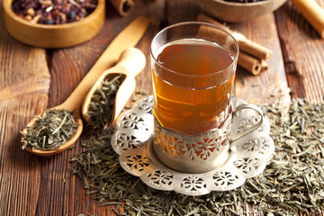 Glass of tea and dried tea leaves