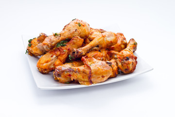appetizing chicken legs on grill with golden crust