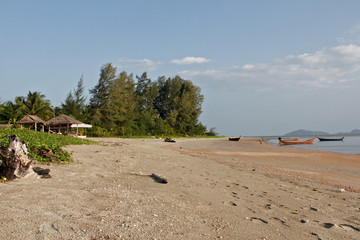 a village on an island in Thailand 
Boats on the beach