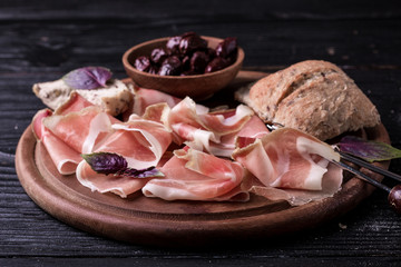 Curled Slices of Delicious Prosciutto with spice  Italian cuisine