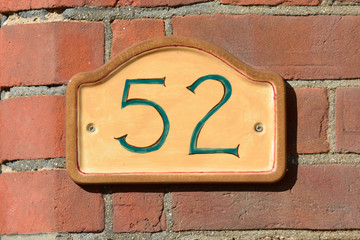 House Number 52 sign on wall