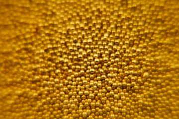 Abstract sparkling gold background with gold balls. Background. Texture.