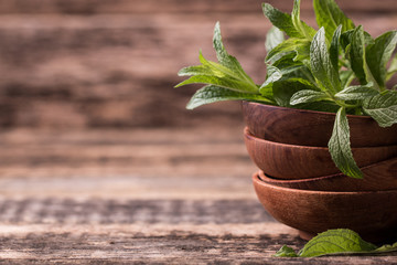 Green fresh mint on the wooden table, selective focus