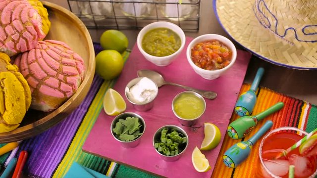 Party table with tamales, strawberry margaritas and pan dulche bread