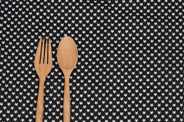 Color tablecloth, spoon, fork on  table background