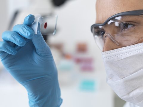 Scientist with microscope slide