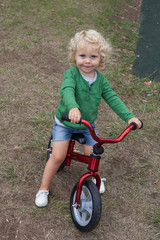 Little kid riding his bike down