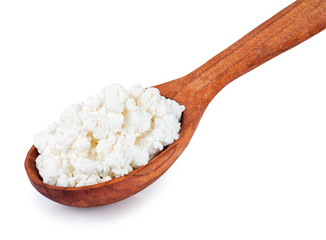 Cottage cheese in wooden spoon isolated on white closeup