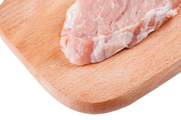 piece of  raw meat pork on wooden board isolated closeup