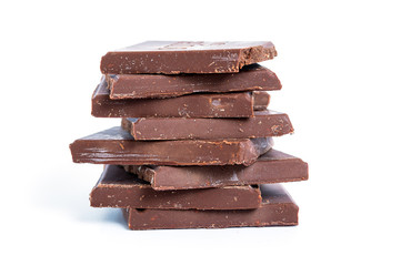 Cracked chocolate blocks stack on white background